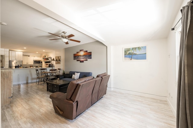 living room with light wood-type flooring, ceiling fan, baseboards, and recessed lighting