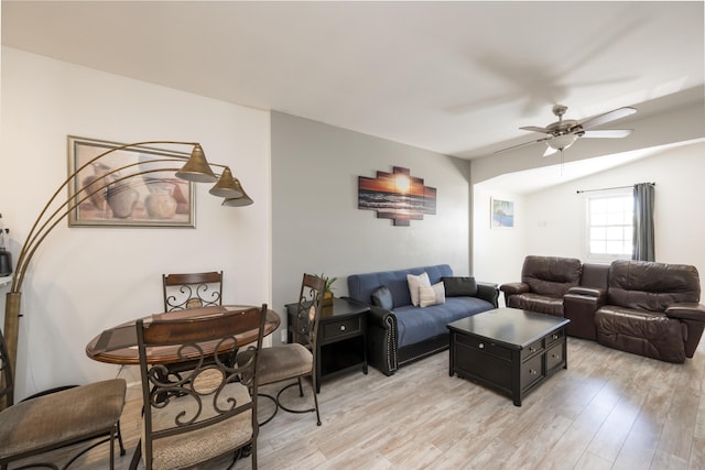 living room with vaulted ceiling, light wood finished floors, and ceiling fan