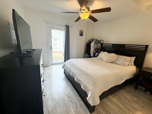 bedroom featuring access to exterior, ceiling fan, and light wood-style flooring