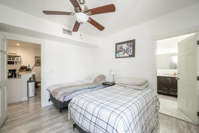 bedroom with ceiling fan, light wood-type flooring, ensuite bath, and visible vents