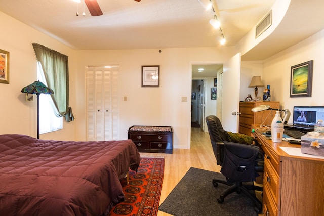 bedroom with ceiling fan and light hardwood / wood-style floors