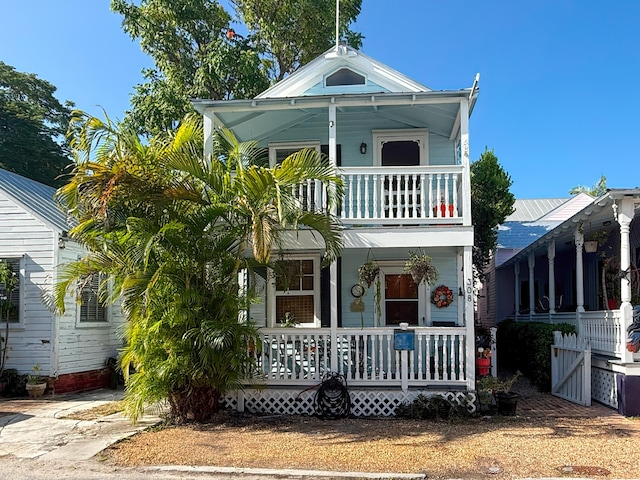 view of front facade featuring a balcony and covered porch