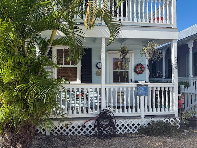 property entrance with a balcony and covered porch