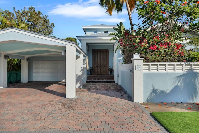 view of front facade with a carport and a garage