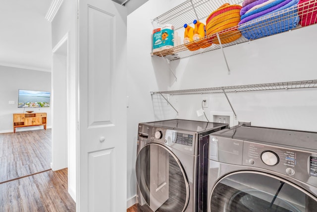 1777 Pine Channel Dr, Little Torch, FL 33042 - laundry room with washing machine and clothes dryer, ornamental molding, and wood finished floors