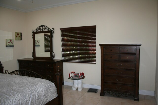 tiled bedroom featuring crown molding