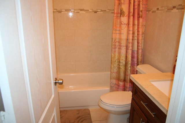 full bathroom with shower / tub combo with curtain, tile patterned flooring, tile walls, vanity, and toilet