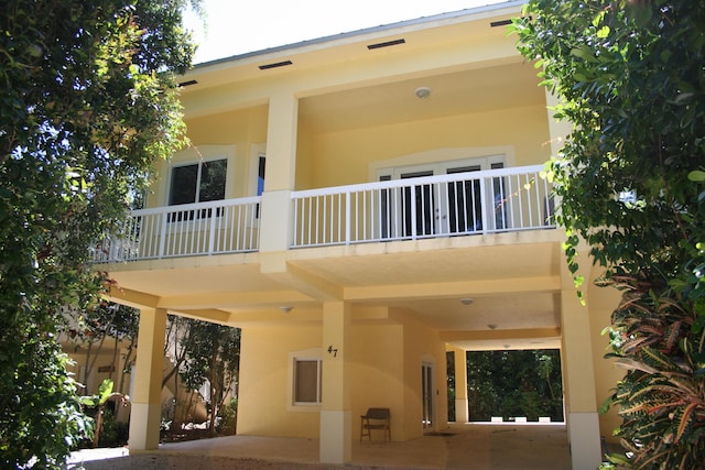 back of property featuring a balcony