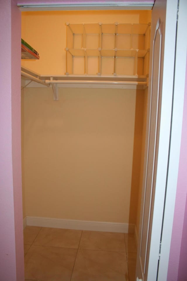 spacious closet featuring light tile patterned floors