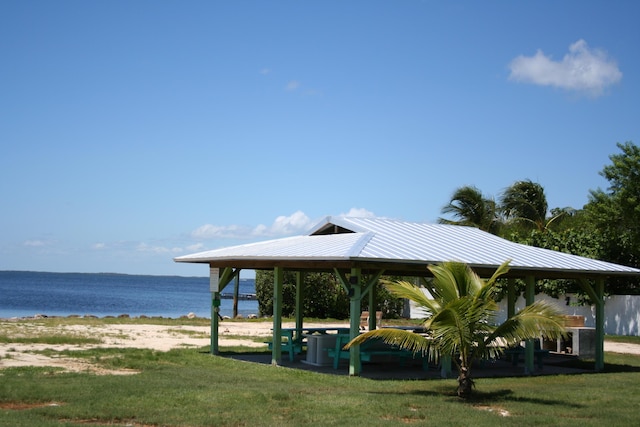 view of community with a yard, a gazebo, and a water view