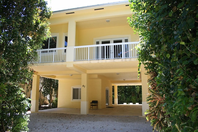 rear view of property featuring a balcony