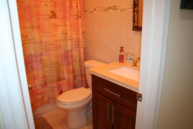 bathroom featuring toilet, tile walls, vanity, a shower with shower curtain, and tile patterned flooring