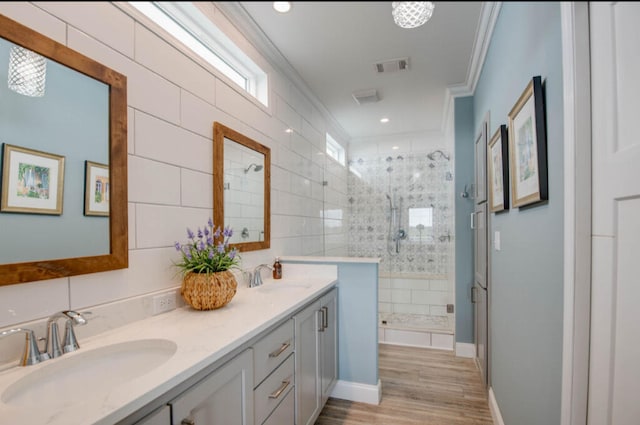 bathroom with crown molding, vanity, an enclosed shower, and hardwood / wood-style flooring