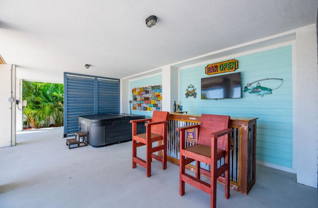 interior space featuring a hot tub and an outdoor bar