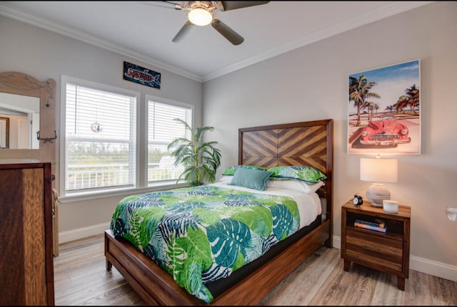 bedroom featuring ornamental molding, wood-type flooring, and ceiling fan