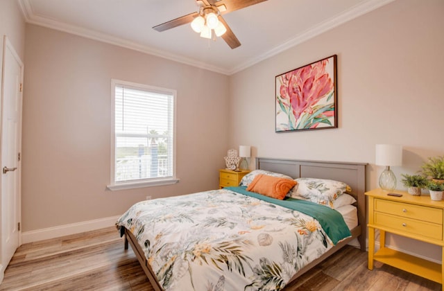 bedroom with hardwood / wood-style flooring, crown molding, and ceiling fan