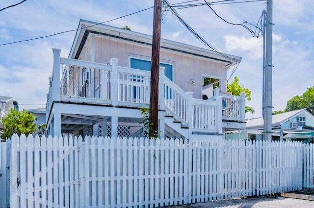 928 Truman Ave Unit 101, Key West, FL 33040 - view of front of home with a fenced front yard and stairway