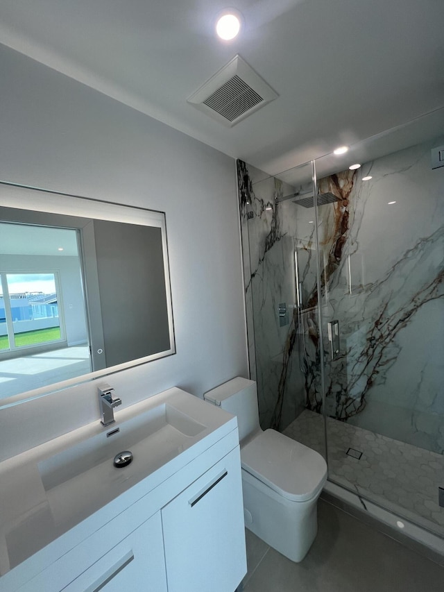 bathroom with vanity, an enclosed shower, and toilet