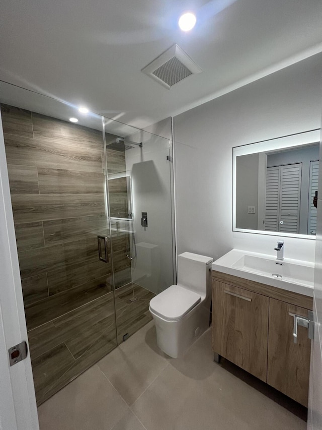 bathroom featuring vanity, toilet, and walk in shower