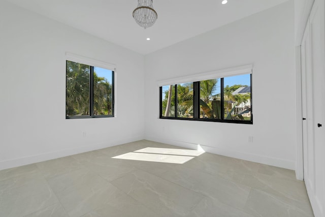 empty room with recessed lighting, baseboards, a notable chandelier, and marble finish floor