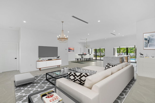living area featuring visible vents, recessed lighting, and a chandelier