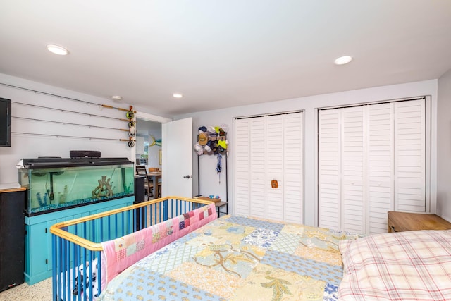 bedroom featuring recessed lighting and two closets