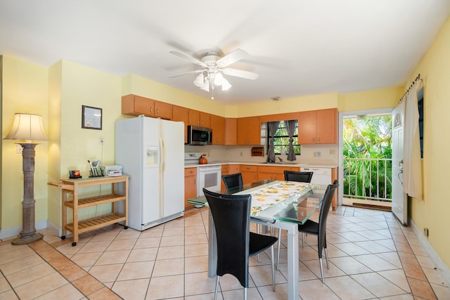 kitchen featuring white appliances, ceiling fan, and light tile patterned flooring