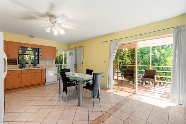 dining room with light tile patterned floors, plenty of natural light, sink, and ceiling fan