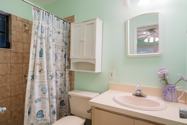 bathroom with vanity, curtained shower, and toilet