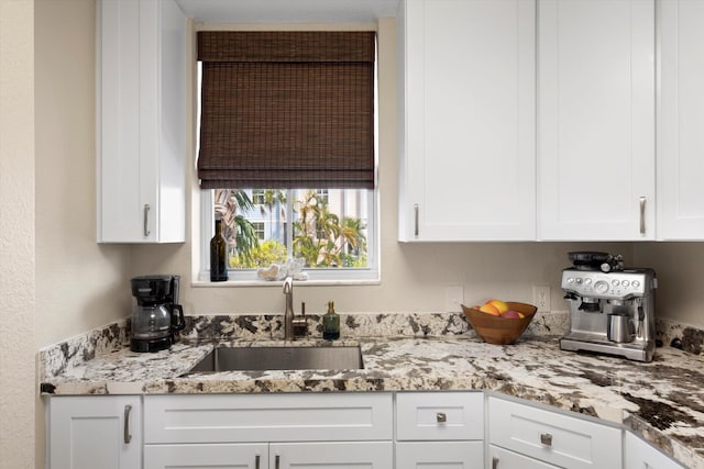 64 Seaside N Ct, Key West, FL 33040 - kitchen with white cabinetry and light stone counters