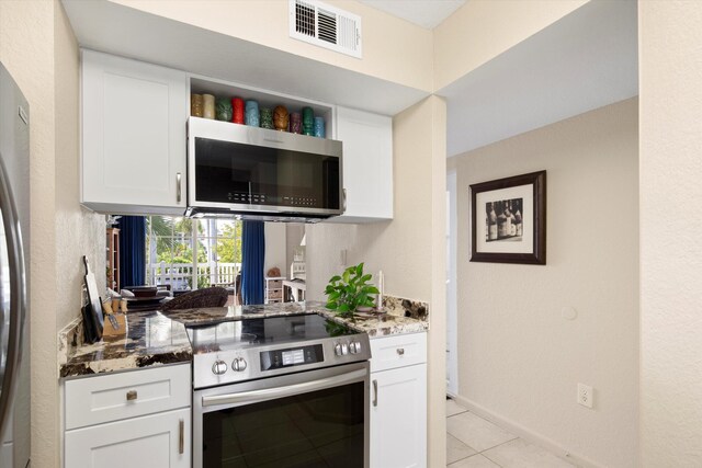 64 Seaside N Ct, Key West, FL 33040 - kitchen with appliances with stainless steel finishes, stone countertops, and white cabinets