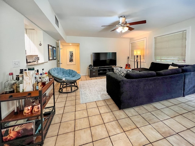 tiled living room with ceiling fan