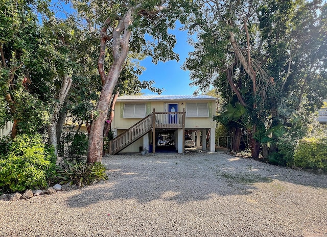 raised beach house featuring a carport