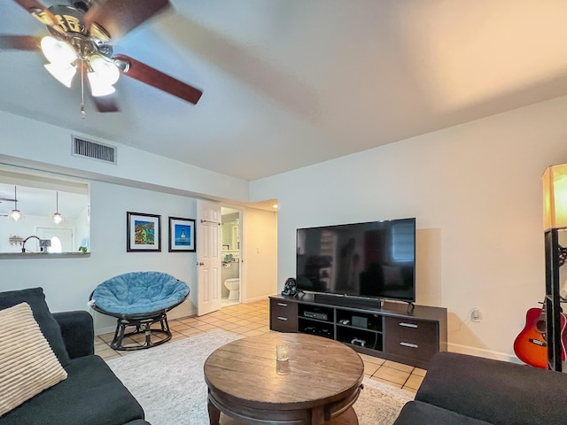 tiled living room with ceiling fan