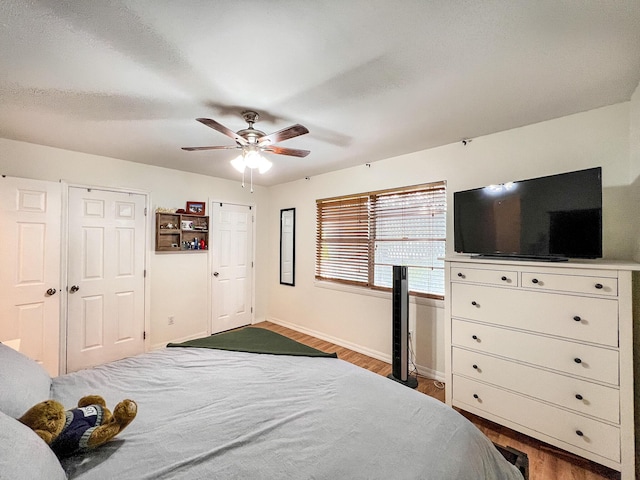 bedroom with hardwood / wood-style floors and ceiling fan