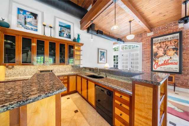 kitchen featuring dark stone counters, black dishwasher, kitchen peninsula, pendant lighting, and brick wall