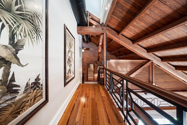 hallway featuring beamed ceiling, hardwood / wood-style floors, and wooden ceiling