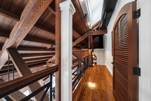 wine area featuring wood-type flooring, wooden ceiling, and beamed ceiling