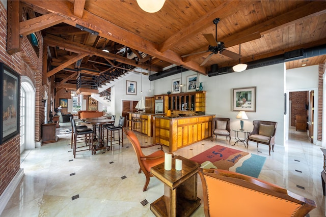 living room with ceiling fan, wooden ceiling, and beamed ceiling