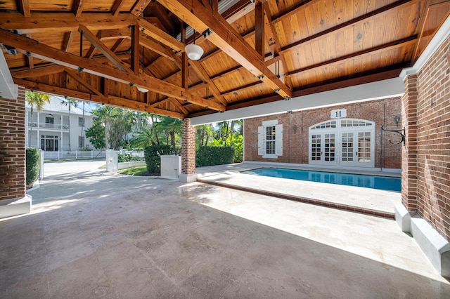 view of swimming pool with a patio area and french doors