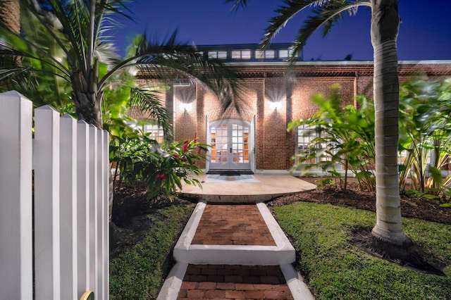 exterior entry at night featuring french doors