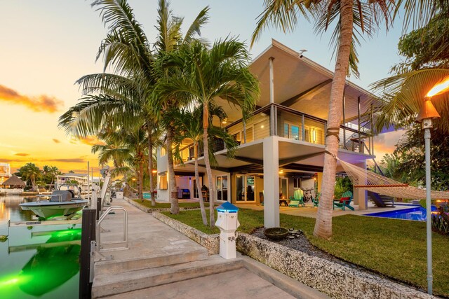 188 Indian Mound Trl, Islamorada, FL 33036 - property at dusk with boat lift and an outdoor pool