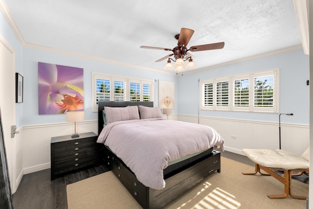 188 Indian Mound Trl, Islamorada, FL 33036 - bedroom featuring wood finished floors, ornamental molding, a wainscoted wall, and a ceiling fan
