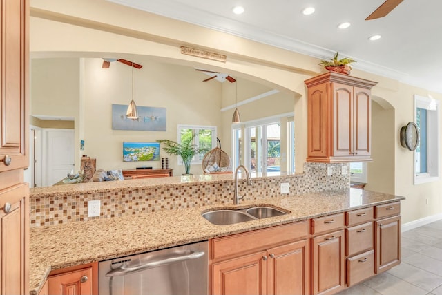 kitchen featuring light stone counters, backsplash, a sink, crown molding, and stainless steel dishwasher