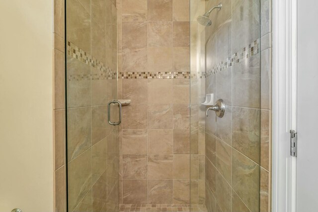 full bath featuring a shower stall