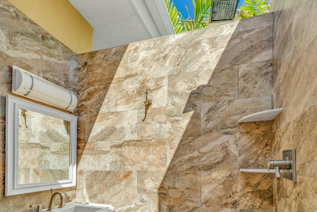 details with tiled shower and a sink