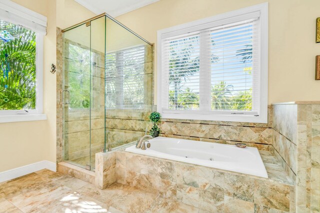 full bath featuring a stall shower, baseboards, and a bath