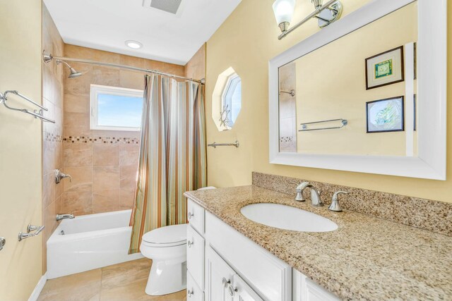 full bathroom featuring toilet, vanity, visible vents, tile patterned floors, and shower / bath combination with curtain