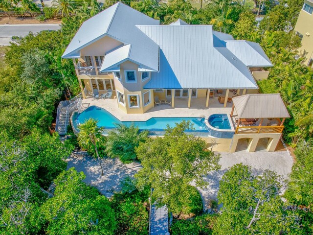 exterior space with a pool with connected hot tub and a patio area