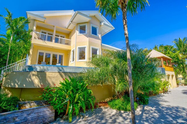 exterior space with a balcony and stucco siding